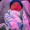 Micah is registered to the contest to win money with this photo: baby, sleeping, infant, onesie, dinosaur_pattern, hat, beanie, blanket, cozy, soft_lighting, indoor, child, cute, portrait, newborn, peaceful, resting, fabric, warm, toddler