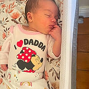 Davina-Leigh joined the competition — help win amazing prizes! baby, sleeping, newborn, infant, clothing, onesie, minnie_mouse, pattern, floral, blanket, bassinet, wood_floor, hand, peaceful, cute, indoor, person, child, resting, soft_light