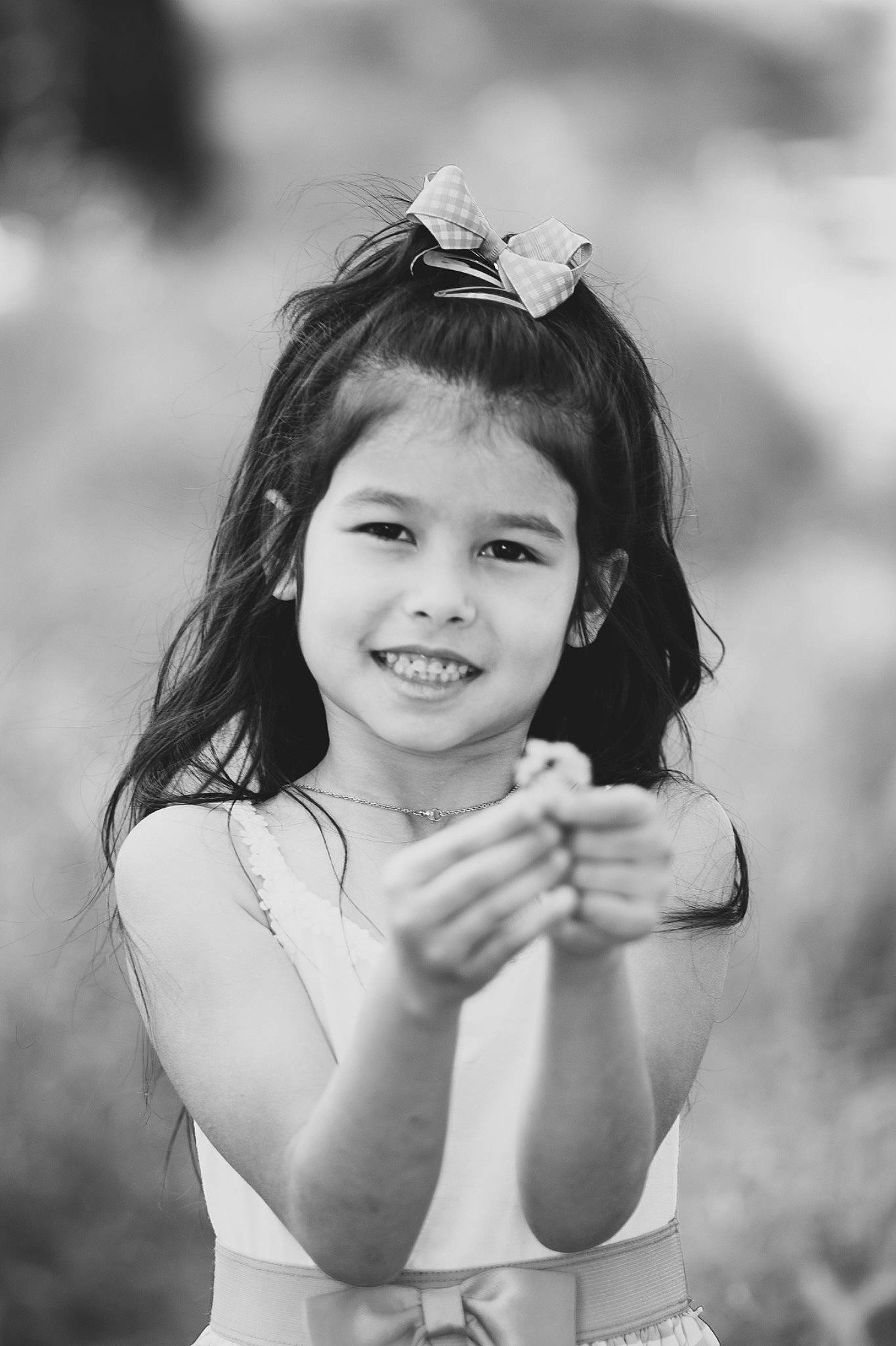 Eiliyah is registered to the contest to win money with this photo: black_and_white, eye, eyelash, flash_photography, gesture, grass, hand, happy, human_body, iris, joy, lip, people_in_nature, person, photograph, plant, skin, smile, standing, style