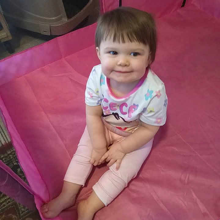 Lindsey joined the competition — help win amazing prizes! toddler, child, smiling, pink_playpen, indoor, clothing, barefoot, sitting, floor, carpet, face, hair, cute, young_child, person, play_area, happy, baby, small_child, casual