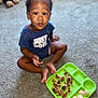 toddler, child, carpet, floor, food, plate, snack, sitting, curious, clothing, indoor, expression, looking_up, young_child, playful, blue_shirt, green_plate, meal, casual, home
