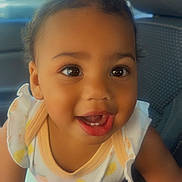 Juanita joined the competition — help win amazing prizes! baby, car, child, clothing, cute, eyes, face, hair, happy, indoors, interior, mouth, person, portrait, seat, sitting, skin, smiling, toddler, young