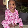 toddler, child, smiling, pink_pajamas, indoor, glass_table, plant, happy, cute, sitting, portrait, face, person, home, cozy, baby, clothing, feet, tongue_out, playful
