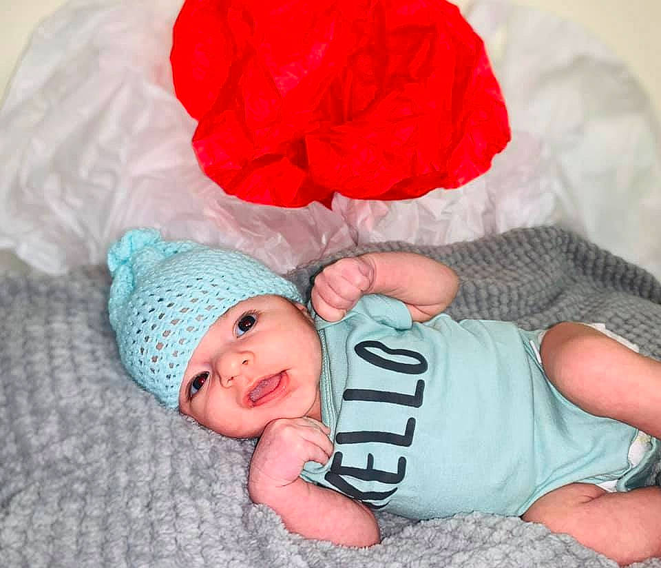 Noel joined the competition — help win amazing prizes! baby, baby_sleeping, baby_toddler_clothing, beanie, child, headgear, headwear, person, toddler, turquoise