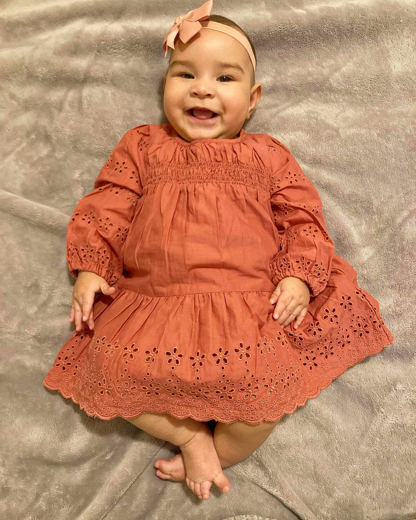 Leila is registered to the contest to win money with this photo: baby, baby_toddler_clothing, cheek, child, day_dress, dress, eye, face, fun, happy, head, headwear, joy, magenta, pattern, peach, person, pink, sitting, skin