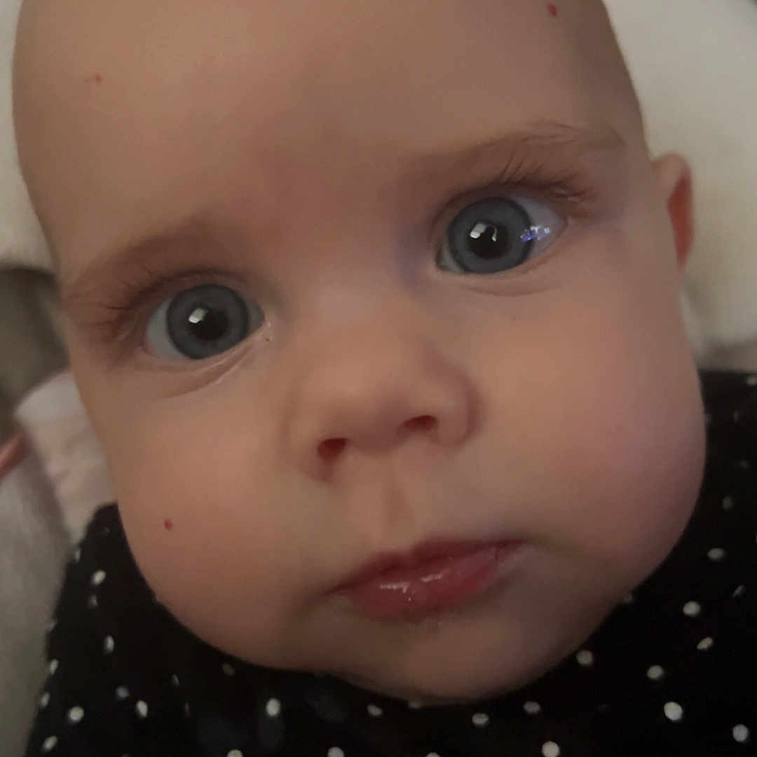 Willow joined the competition — help win amazing prizes! baby, blue_eyes, child, chubby_cheeks, close_up, clothing, cute, expression, face, hand, head, indoor, infant, looking_at_camera, person, polka_dot, portrait, skin, soft_lighting, young_child