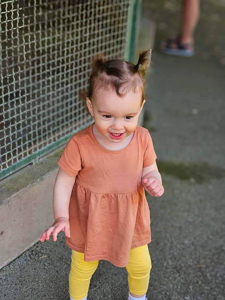 Teodora participe au concours pour gagner de l'argent avec cette photo : baby, baby_toddler_clothing, child, dress, eye, face, flooring, fun, grass, hair, happy, human_leg, joy, leisure, mesh, person, pink, recreation, sitting, sleeve