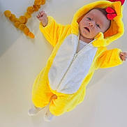 Liza a rejoint le concours — aidez-le/la à gagner de superbes lots ! baby, infant, costume, yellow, chicken, animal_costume, dried_apricots, fruit, number_seven, white_background, cute, lying_down, soft_texture, hooded_outfit, child, portrait, expression, playful, food_arrangement, indoor