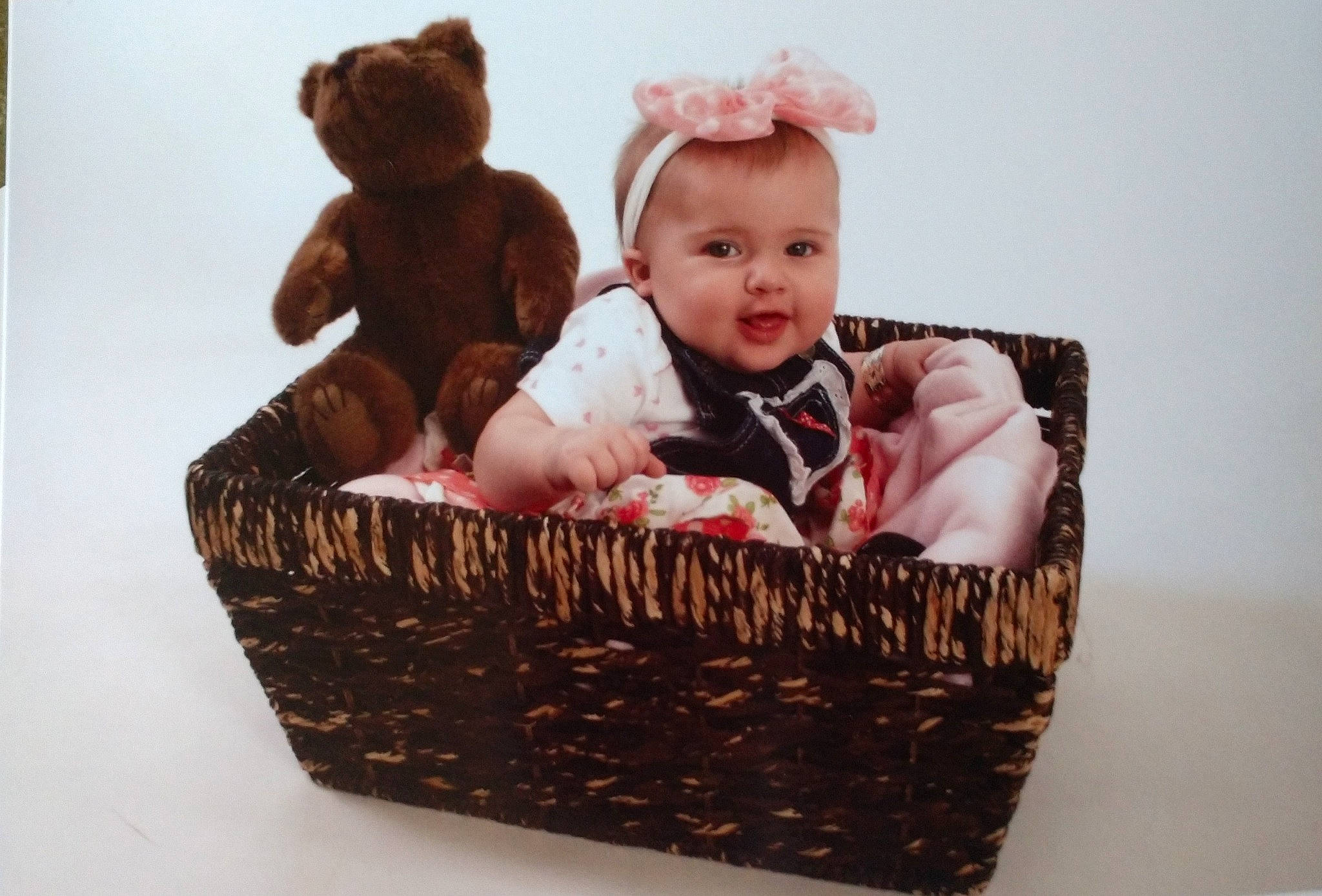 Lucille is registered to the contest to win money with this photo: baby, baby_products, baby_toddler_clothing, basket, brown, child, gift_basket, hamper, home_accessories, person, present, product, storage_basket, toddler, wicker