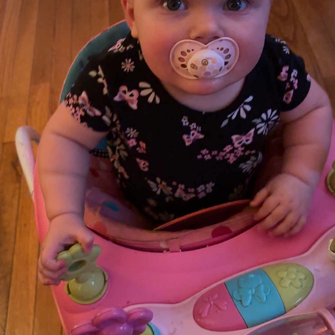 Mavis is registered to the contest to win money with this photo: baby, bodypart, clothing, cutlery, electronics, face, finger, furniture, hand, hardwood, head, mobilephone, person, phone, photography, portrait, sitting, spoon, t_shirt, wood