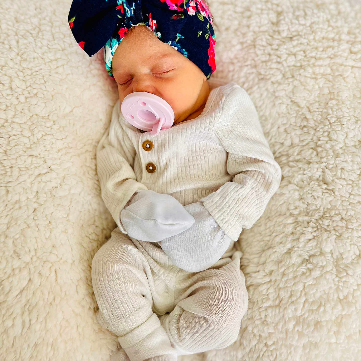 Kamiah joined the competition — help win amazing prizes! baby, blanket, child, closeup, cozy, cute, floral, headband, indoors, infant, mittens, newborn, pacifier, peaceful, portrait, resting, ribbed_clothing, sleeping, soft_texture, white_clothing