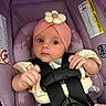 baby, infant, car_seat, headband, flower, pink, purple, seatbelt, child, cute, wide_eyes, clothing, safety, hands, portrait, indoor, person, young, adorable, baby_girl