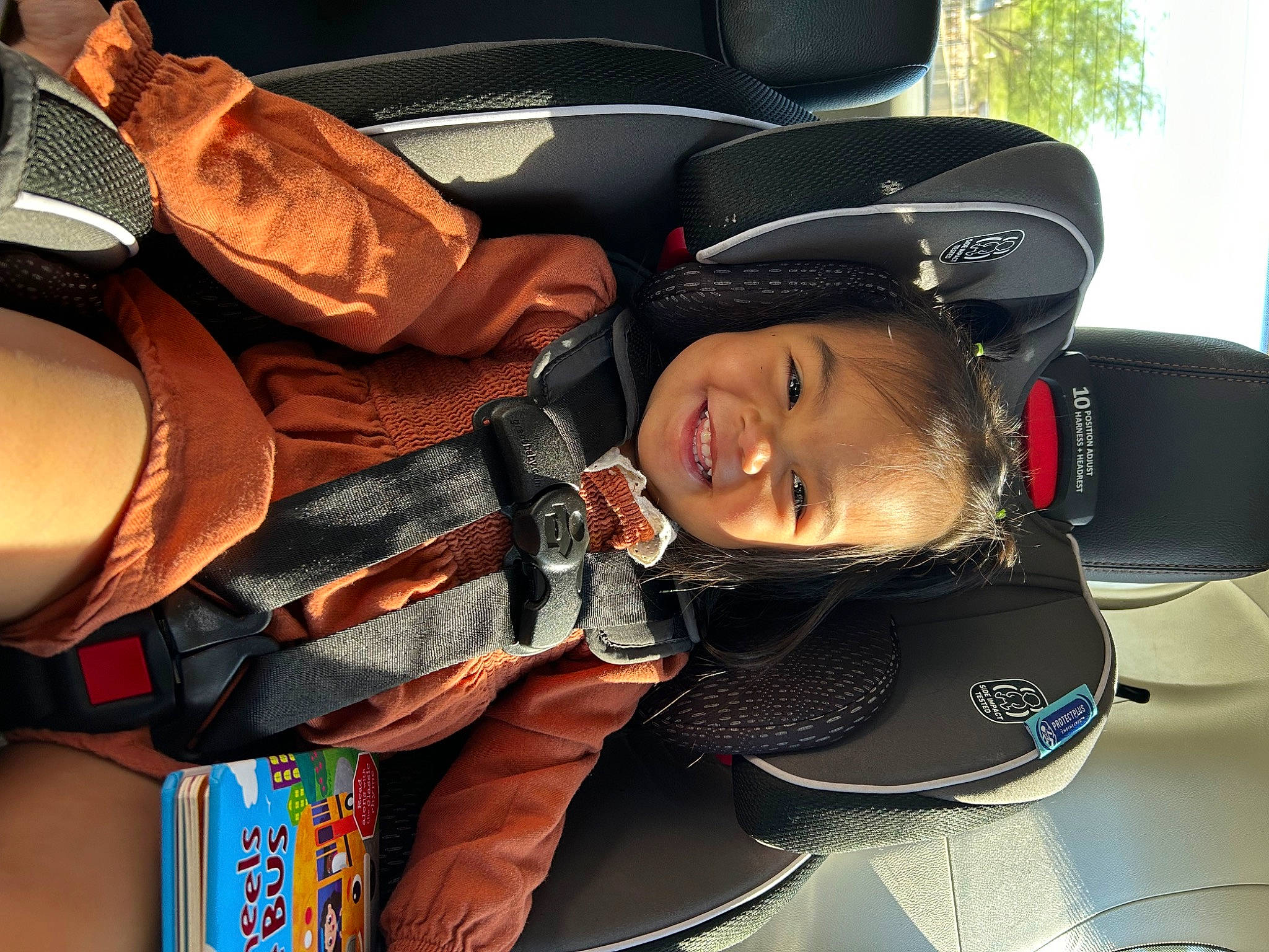 Inez is registered to the contest to win money with this photo: auto_part, automotive_design, bag, eyewear, family_car, fashion_accessory, head_restraint, headgear, helmet, joy, luggage_and_bags, motor_vehicle, motorcycle_helmet, person, personal_protective_equipment, smile, sports_equipment, sports_gear, tree, vehicle