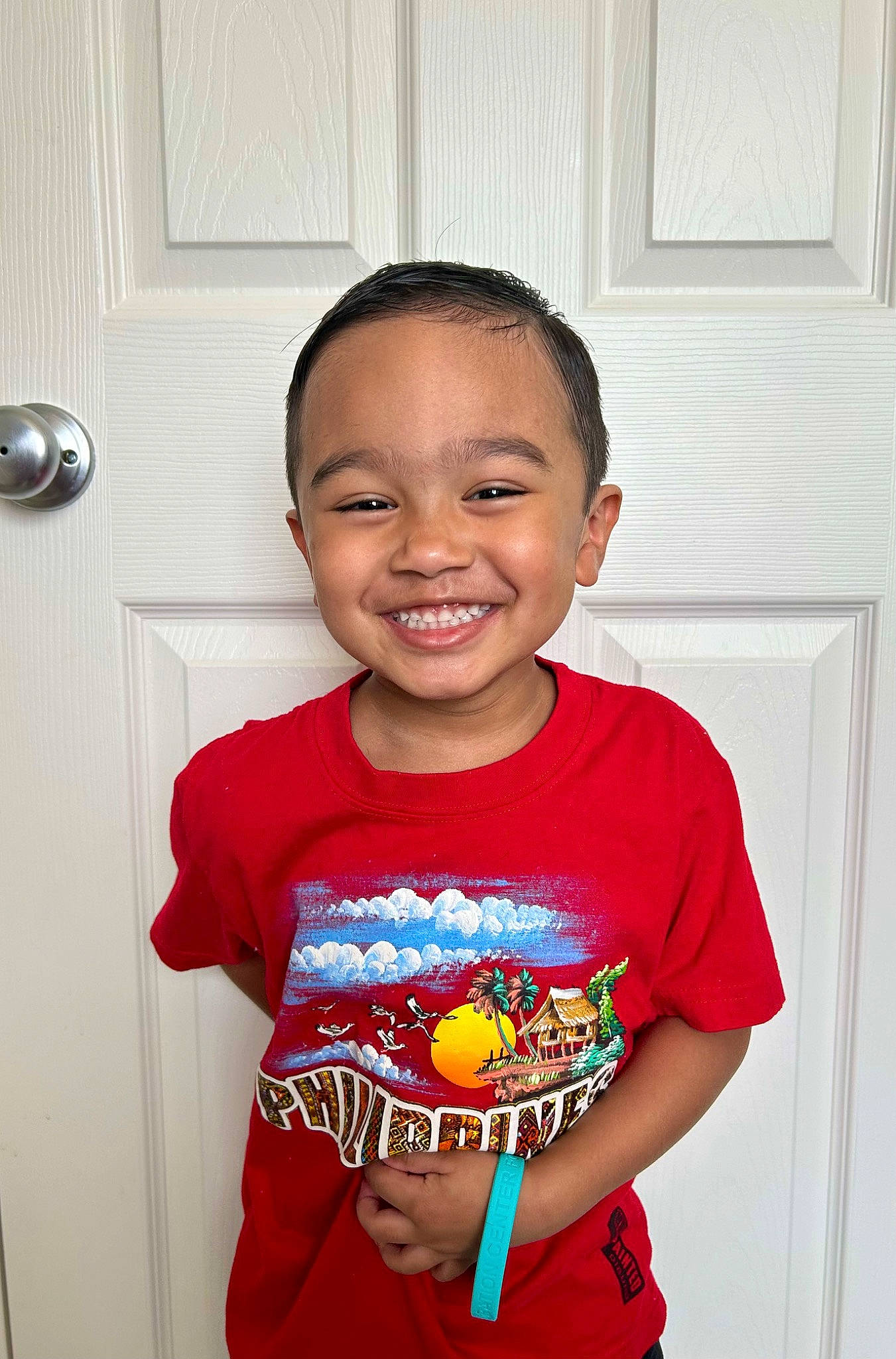 Cristian is registered to the contest to win money with this photo: baby_toddler_clothing, child, chin, door, electric_blue, eye, facial_expression, fun, hairstyle, happy, joy, muscle, person, red, room, skin, sleeve, smile, standing, t_shirt
