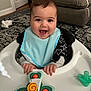 Spencer joined the competition — help win amazing prizes! baby, smiling, bib, baby_walker, toy, pacifier, living_room, carpet, couch, plush_toy, happy, child, indoor, furniture, clothing, hands, face, portrait, infant, black_hair