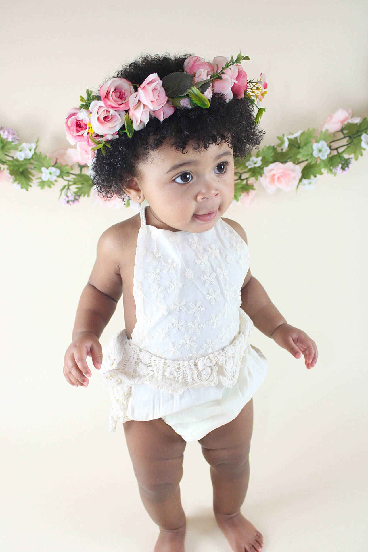 Stella is registered to the contest to win money with this photo: baby_toddler_clothing, embellishment, eye, face, finger, flower, hair, happy, head, headgear, leg, person, petal, pink, plant, product, sleeve, textile, thigh, trunk
