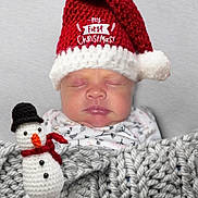 Saraphina is registered to the contest to win money with this photo: baby, infant, sleeping, hat, santa_hat, red_hat, knit_hat, blanket, knit_blanket, crocheted, snowman, toy, christmas, holiday, cozy, cute, face, closed_eyes, child, festive