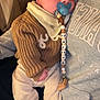 Jayden a rejoint le concours — aidez-le/la à gagner de superbes lots ! baby, infant, sleeping, pacifier, beaded_clip, sweater, bib, couch, person, hoodie, legs, socks, hand, peaceful, indoors, closeup, portrait, soft_lighting, relaxing, toddler_accessory