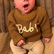 Jayden participe au concours pour gagner de l'argent avec cette photo : baby, infant, child, knitted_sweater, sweater, yawning, open_mouth, face, eyes, hands, legs, socks, pants, corduroy_pants, blanket, couch, cozy, portrait, home_interior, soft_texture