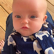 Oaklynne joined the competition — help win amazing prizes! baby, child, infant, blue_eyes, elephant_pattern, onesie, clothing, face, head, skin, person, portrait, indoors, floor, wood, casual, cute, young, sitting, comfort