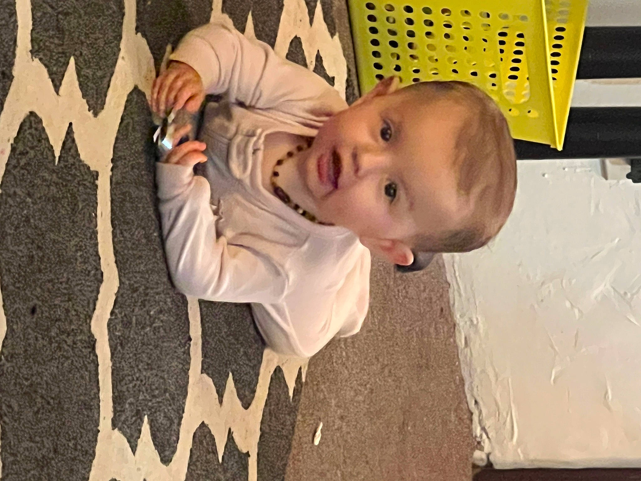 Mariah is registered to the contest to win money with this photo: baby, child, flooring, fun, grass, happy, hat, pattern, person, plant, play, room, shadow, sitting, smile, t_shirt, toddler, tree, visual_arts, wood