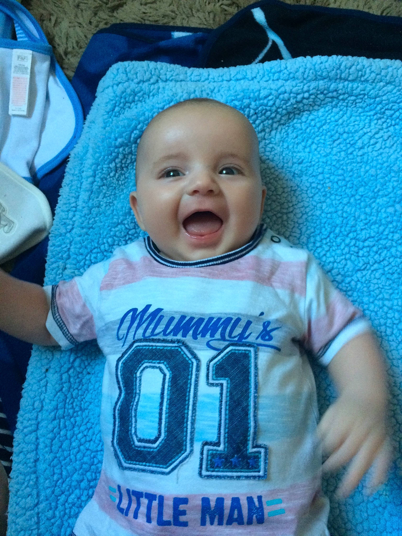 Leo is registered to the contest to win money with this photo: baby, baby_toddler_clothing, blue, child, cool, facial_expression, outerwear, person, product, sleeve, smile, t_shirt, textile, toddler