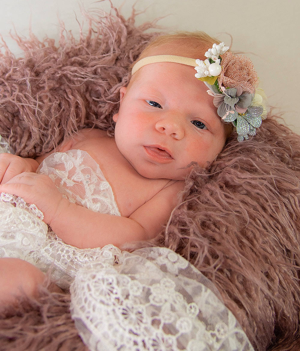 Bria is registered to the contest to win money with this photo: baby, child, child_model, dress, face, fashion_accessory, fur, hair_accessory, headband, headgear, headpiece, iris, person, photograph, photography, pink, portrait_photography, skin, smile, textile