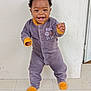 Ravi Manuel participe au concours pour gagner de l'argent avec cette photo : baby, child, onesie, smiling, standing, floor, tile, wall, indoor, happy, cute, person, infant, clothing, footwear, face, expression, young, portrait, playful