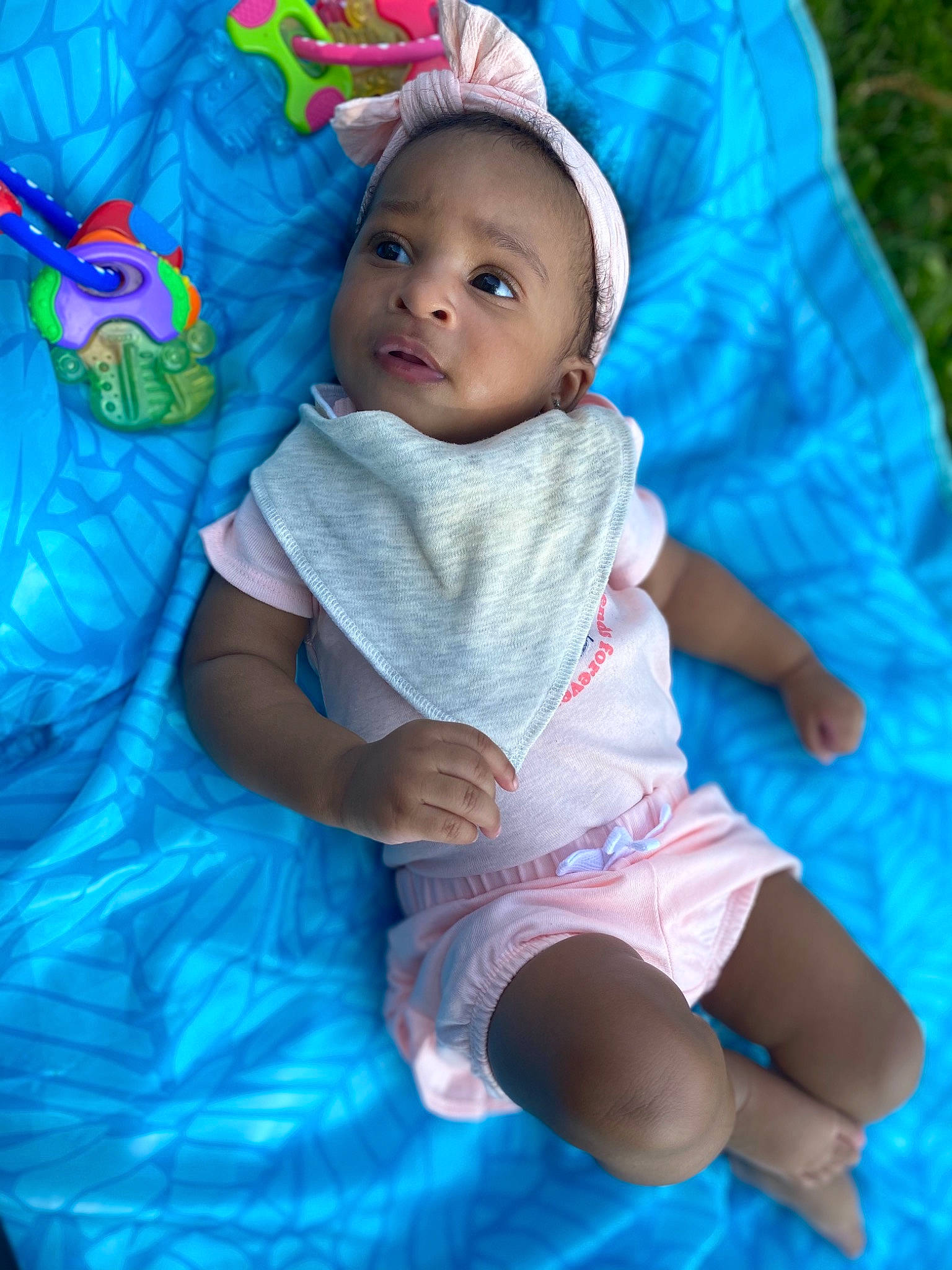 Jenesis is registered to the contest to win money with this photo: aqua, azure, baby, baby_products, baby_toddler_clothing, cheek, child, electric_blue, event, eye, fun, grass, happy, linens, magenta, person, pink, purple, sitting, skin