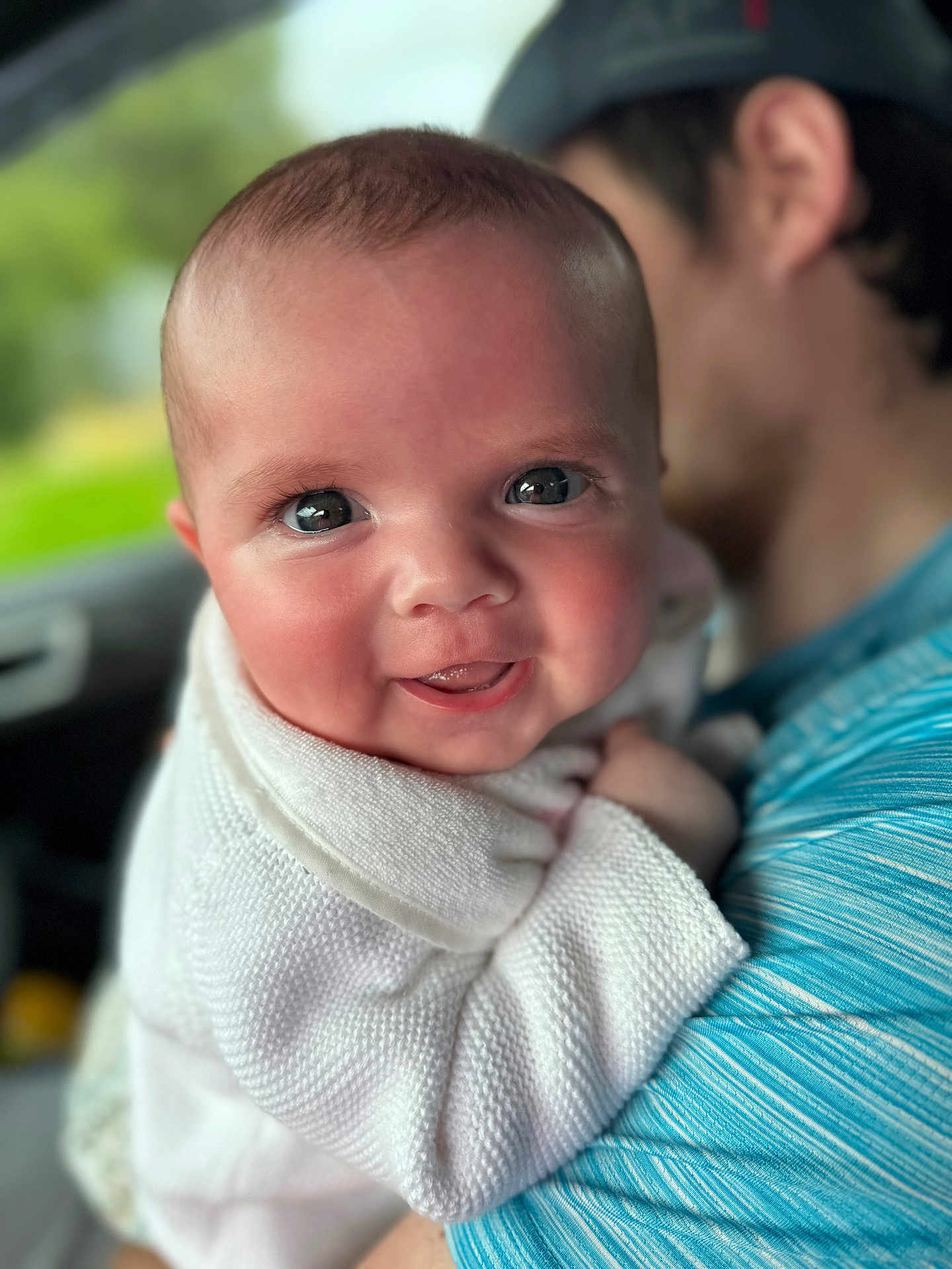 Everleigh-Rose is registered to the contest to win money with this photo: baby, child, smiling, closeup, person, face, sweater, blue_shirt, holding, portrait, happy, cute, infant, human, indoors, blurred_background, skin, eyes, head, family