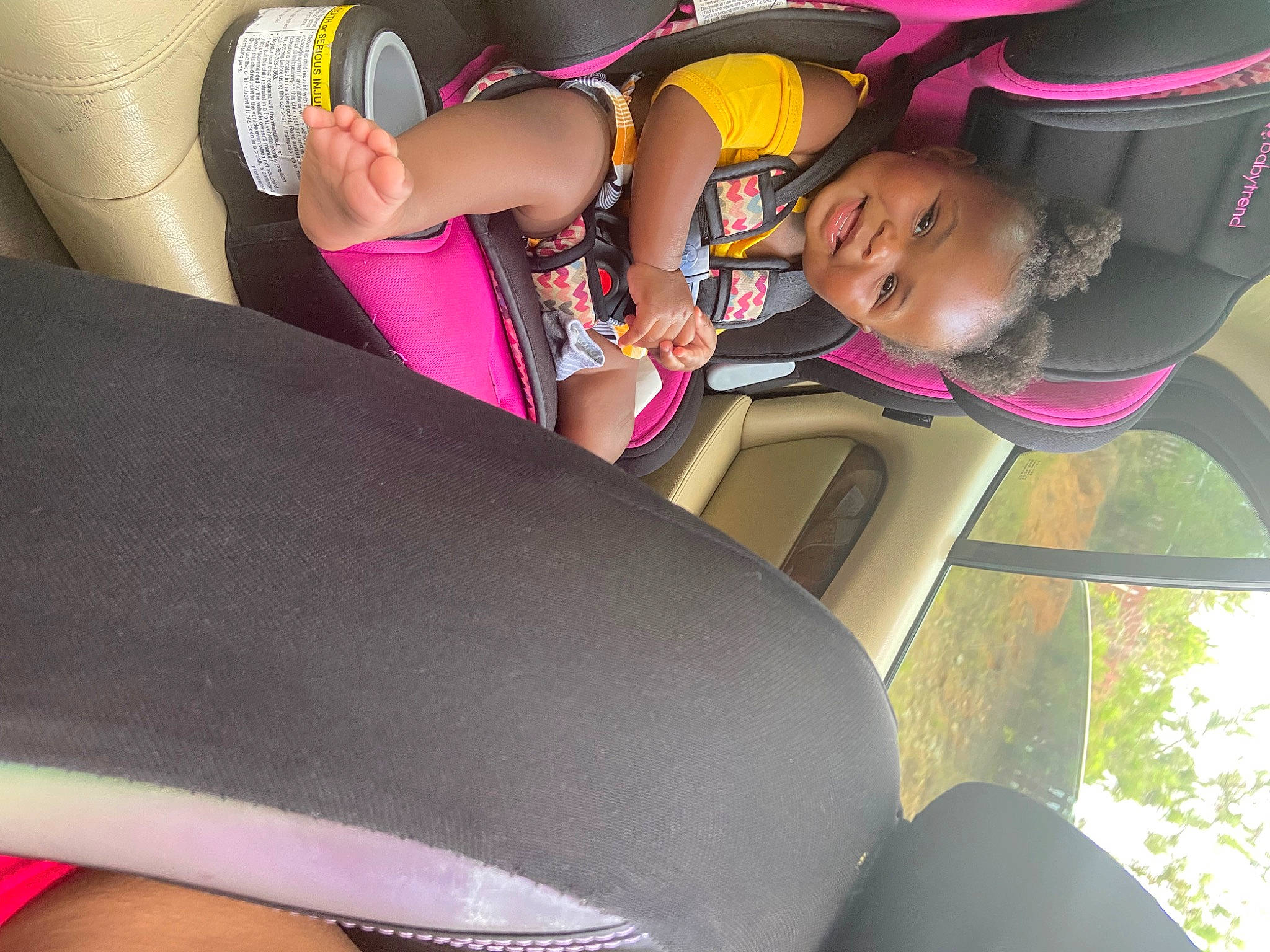 Amoura joined the competition — help win amazing prizes! auto_part, car_seat, comfort, eyewear, fun, happy, hat, human_body, human_leg, knee, leisure, magenta, person, personal_protective_equipment, pink, recreation, smile, thigh, toddler, tree