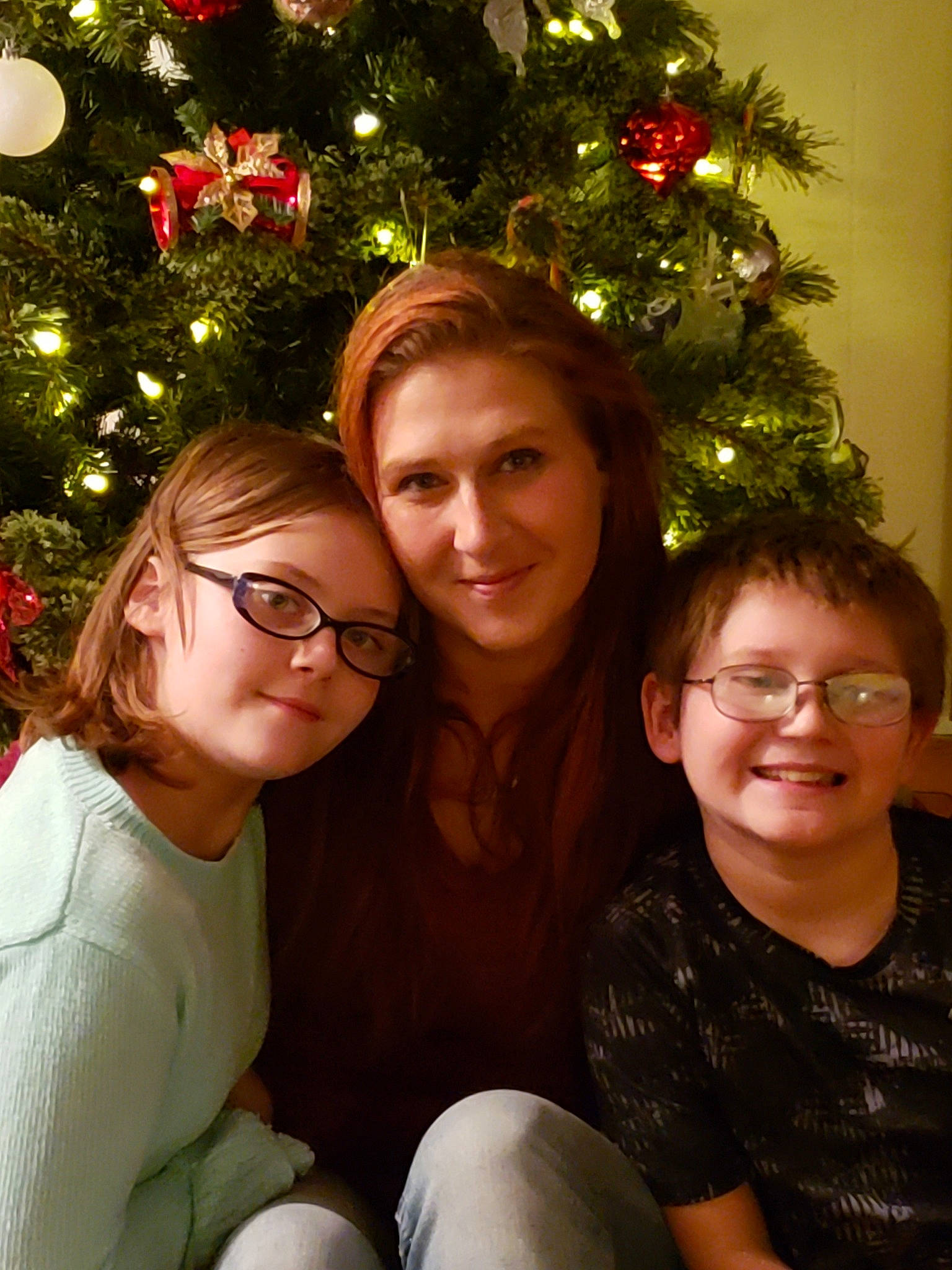 Lilia is registered to the contest to win money with this photo: child, christmas, christmas_decoration, christmas_eve, christmas_lights, christmas_ornament, christmas_tree, event, facial_expression, family, fun, happy, holiday, interior_design, joy, laugh, mother, people, person, plant