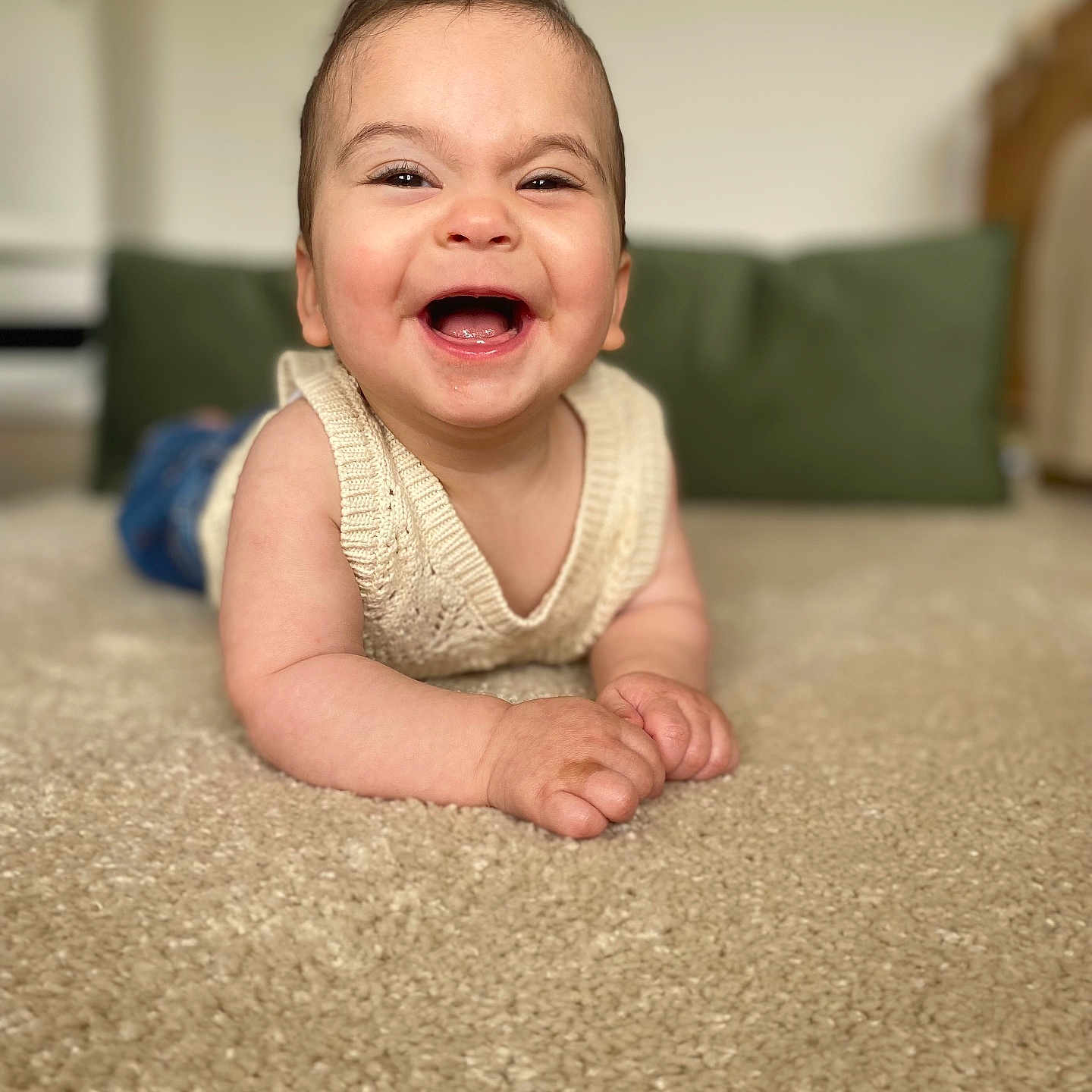 Roukaya participe au concours pour gagner de l'argent avec cette photo : baby, blue_pants, carpet, child, cozy, cushion, cute, face, green, happy, home, indoor, infant, knitwear, lying_down, person, portrait, sleeveless, smiling, young_child