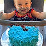 baby, child, high_chair, cake, blue_frosting, smiling, face_paint, messy, celebration, food, birthday, happy, indoor, cosco_kids, clothing, party, sweet, hands, table, young_child