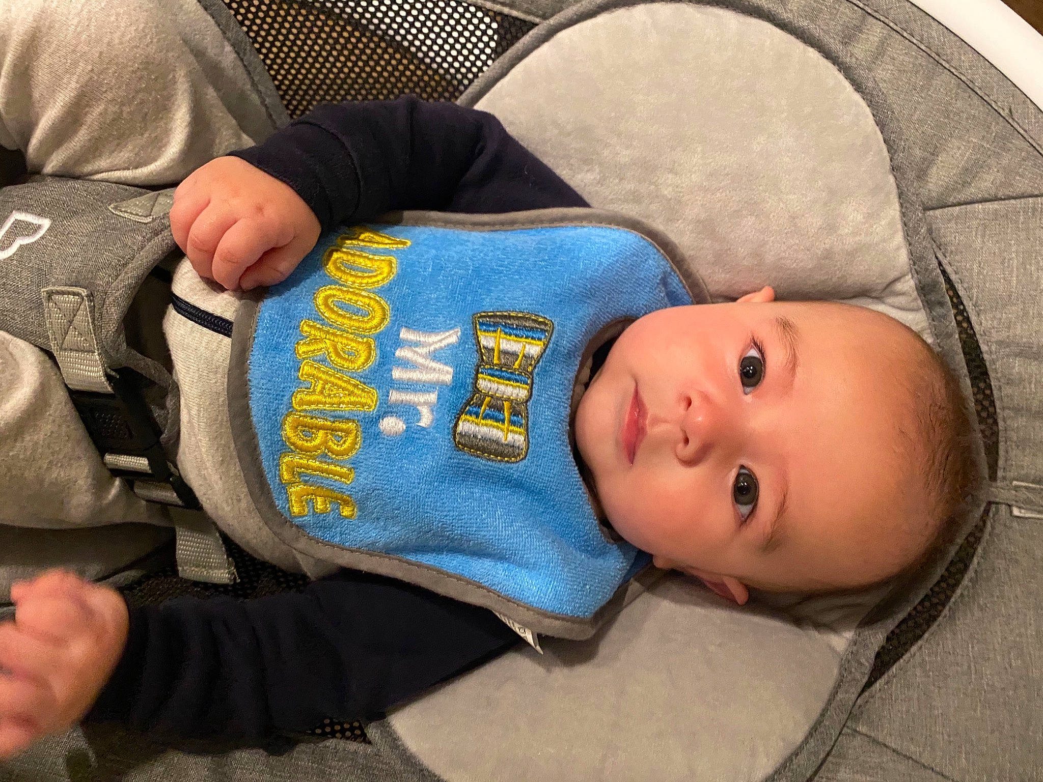 Graham is registered to the contest to win money with this photo: baby, baby_products, baby_toddler_clothing, cheek, child, comfort, elbow, electric_blue, face, gesture, hand, head, headgear, person, sitting, skin, sleeve, textile, toddler, wood