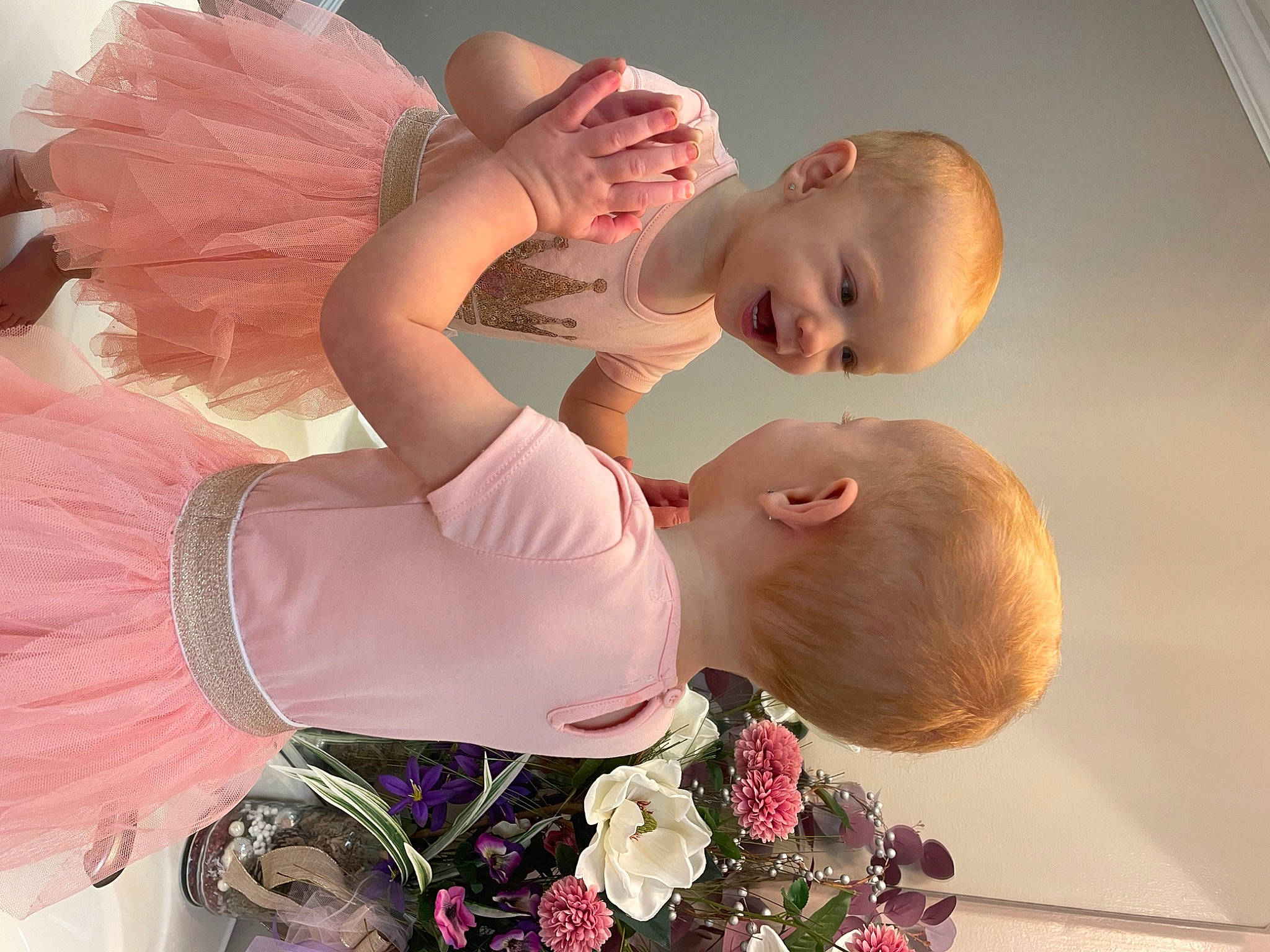 Charity is registered to the contest to win money with this photo: abdomen, baby, blossom, child, cut_flowers, event, fashion_accessory, flower, fun, gesture, hand, happy, human_body, interaction, magenta, peach, person, petal, pink, plant