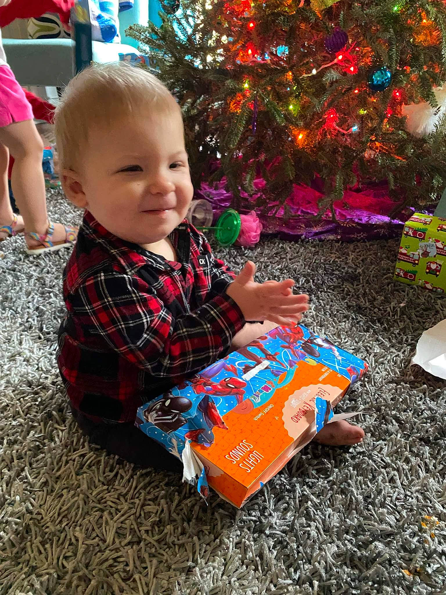Cayson joined the competition — help win amazing prizes! baby, baby_toddler_clothing, child, christmas, christmas_decoration, christmas_ornament, christmas_tree, conifer, event, fun, grass, happy, holiday, holiday_ornament, ornament, person, shorts, sitting, smile, toddler
