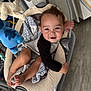 Dallas joined the competition — help win amazing prizes! baby, child, swing, toy, blanket, indoor, smiling, curly_hair, foot, hand, clothing, seat, soft_toy, blue_toy, fabric, floor, person, cute, comfort, happy