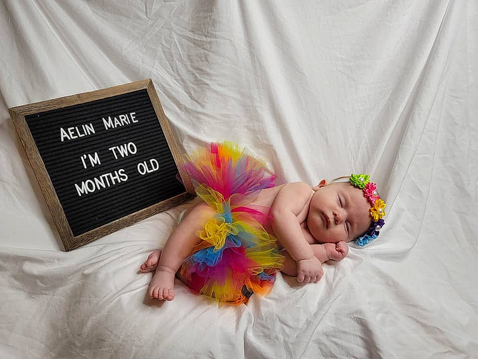 Aelin joined the competition — help win amazing prizes! baby, baby_products, baby_toddler_clothing, child, comfort, fashion_accessory, finger, font, hand, happy, headwear, linens, magenta, nail, party_supply, person, pink, publication, room, textile