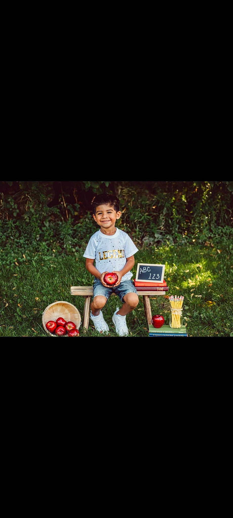 Mateo is registered to the contest to win money with this photo: ball, child, flash_photography, font, fun, grass, happy, joy, lawn, leisure, people_in_nature, person, photo_caption, plant, player, recreation, shorts, sitting, sports_equipment, t_shirt