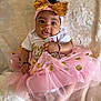 baby, infant, tutu, pink, gold, headband, bow, bracelet, white_blanket, cute, child, portrait, sitting, clothing, soft_texture, happy, hands, feet, face, indoors