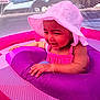 Mylani is registered to the contest to win money with this photo: baby, child, infant, hat, sunhat, pink, purple, inflatable_pool, float_ring, smiling, happy, summer, outdoor, water, mesh_net, arm_bracelet, clothing, playtime, toddler, cute