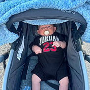 Lavar joined the competition — help win amazing prizes! baby, baby_boy, baby_face, baby_gear, baby_girl, baby_legs, black_onesie, blanket, child, clothing, comfort, cute, infant, infant_clothing, outdoor, pacifier, person, relaxing, stroller, young_child