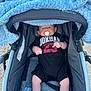 baby, baby_boy, baby_face, baby_gear, baby_girl, baby_legs, black_onesie, blanket, child, clothing, comfort, cute, infant, infant_clothing, outdoor, pacifier, person, relaxing, stroller, young_child