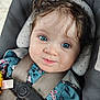 baby, child, face, blue_eyes, curly_hair, car_seat, safety_belt, clothing, floral_pattern, infant, portrait, cute, closeup, child_seat, smile, young_child, person, indoors, seat_belt, baby_clothes