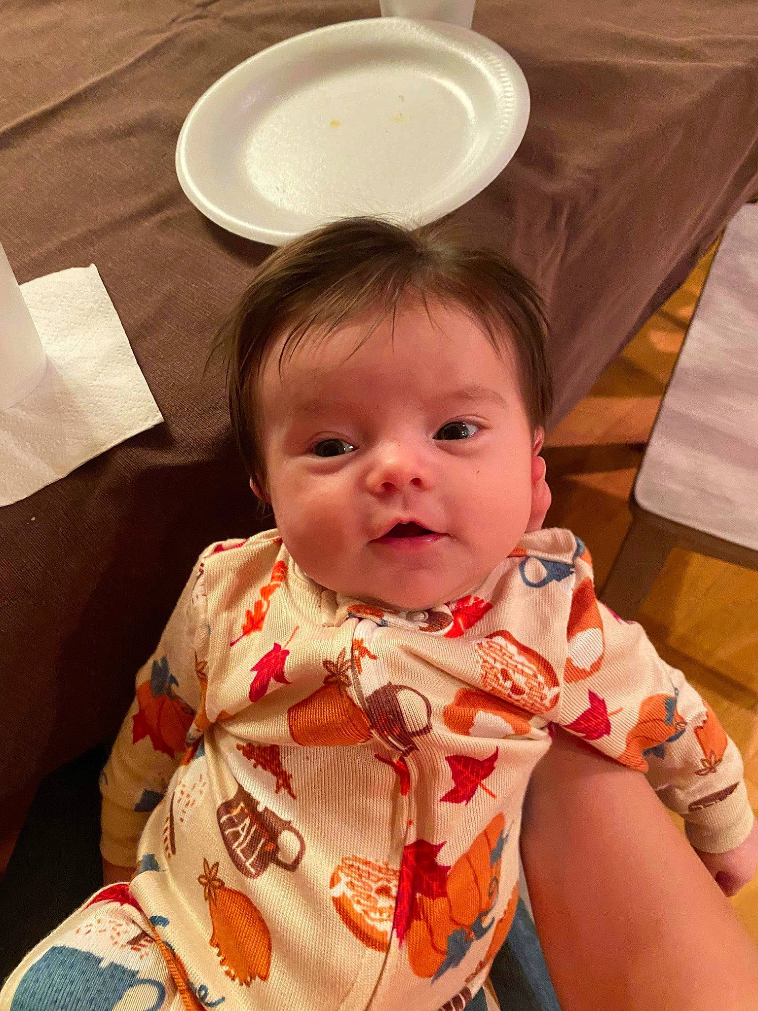 Anaya is registered to the contest to win money with this photo: baby, baby_toddler_clothing, bib, chair, cheek, child, comfort, dishware, drinkware, eye, happy, iris, linens, person, serveware, sitting, skin, sleeve, textile, toddler