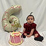 baby, infant, child, cake, balloon, number_6, celebration, milestone, red_dress, sitting, white_background, ribbons, decorations, portrait, cute, birthday, party, smiling, indoors, photography