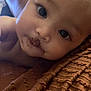 Evangeline joined the competition — help win amazing prizes! baby, face, close_up, messy, chocolate, blanket, texture, curious, lying_down, skin, infant, child, portrait, indoors, candid, cute, expression, soft_light, mouth, eyes