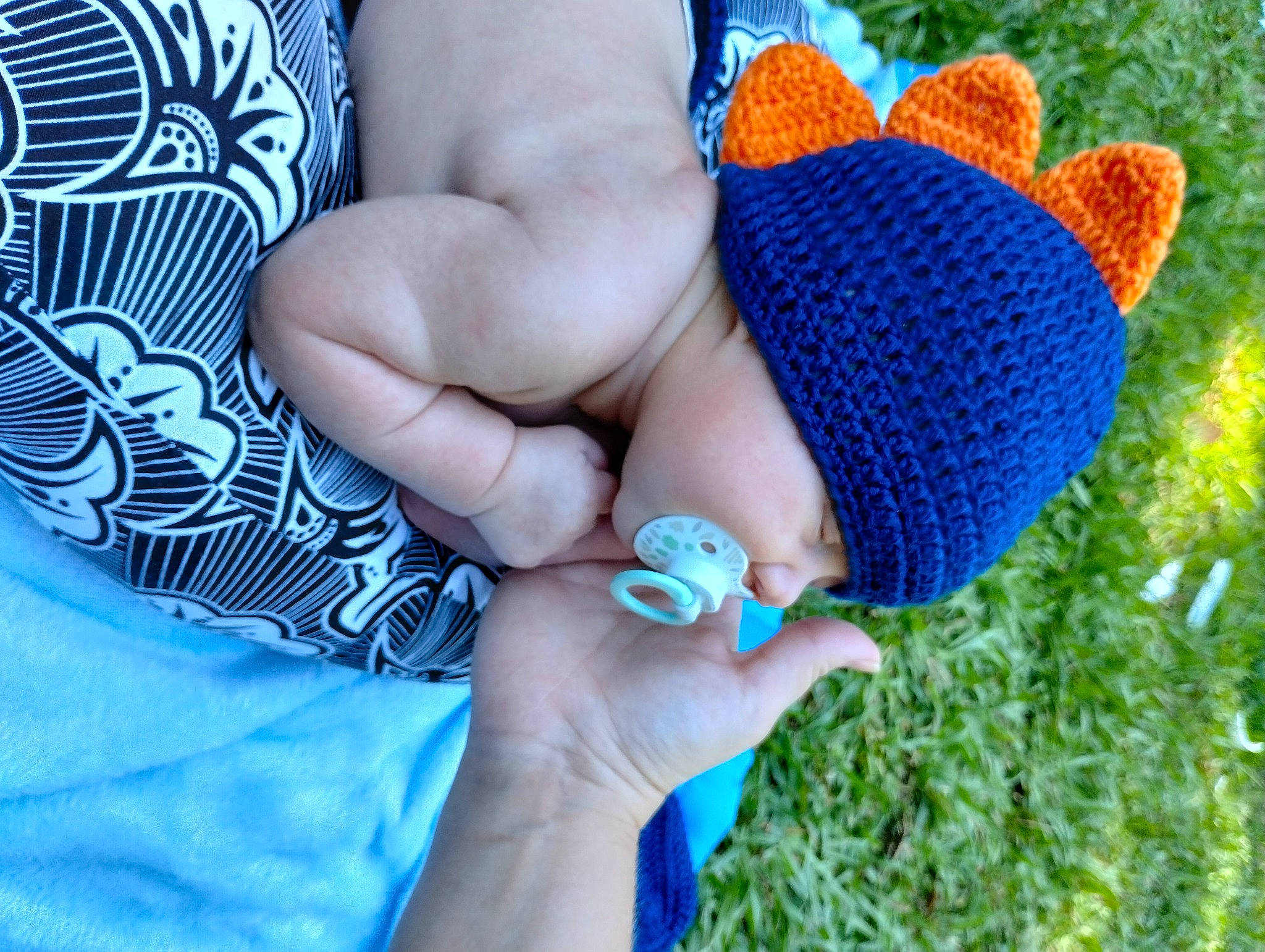 Lane is registered to the contest to win money with this photo: aqua, azure, blue, child, electric_blue, finger, foot, gesture, glove, grass, hand, human_leg, joint, nail, pattern, people_in_nature, person, shoe, textile, thumb