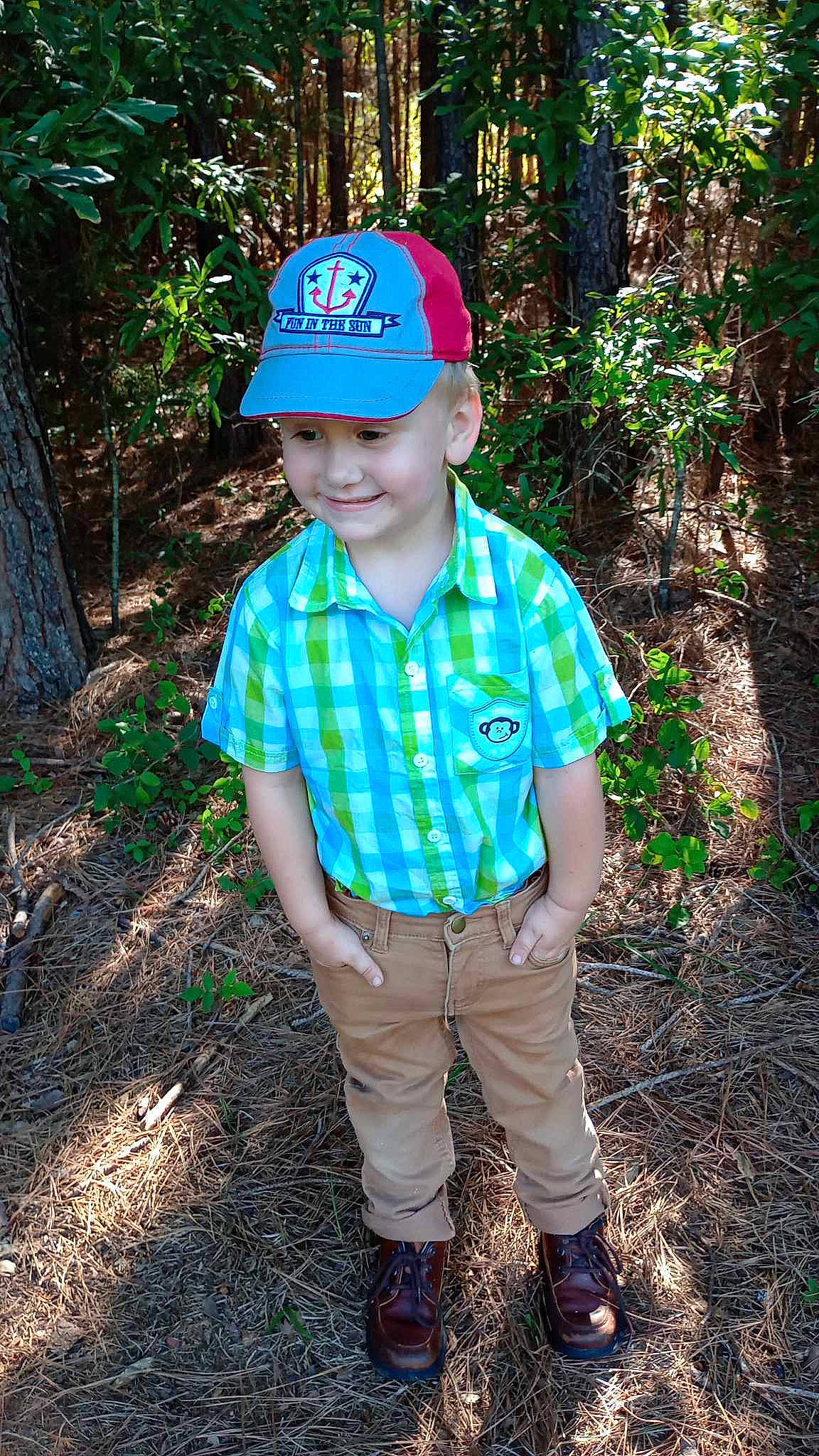 Tyler is registered to the contest to win money with this photo: baby_toddler_clothing, baseball_cap, cap, electric_blue, eye, face, grass, happy, headgear, headwear, joy, leisure, people_in_nature, person, personal_protective_equipment, plant, recreation, sleeve, smile, soil